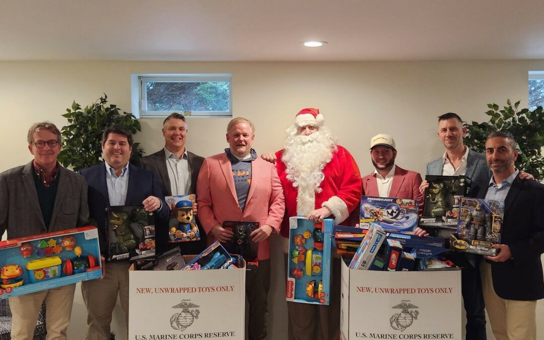 Rodgers Foundation volunteers pose with two boxes of toys that will be donated to Toys For Tots.